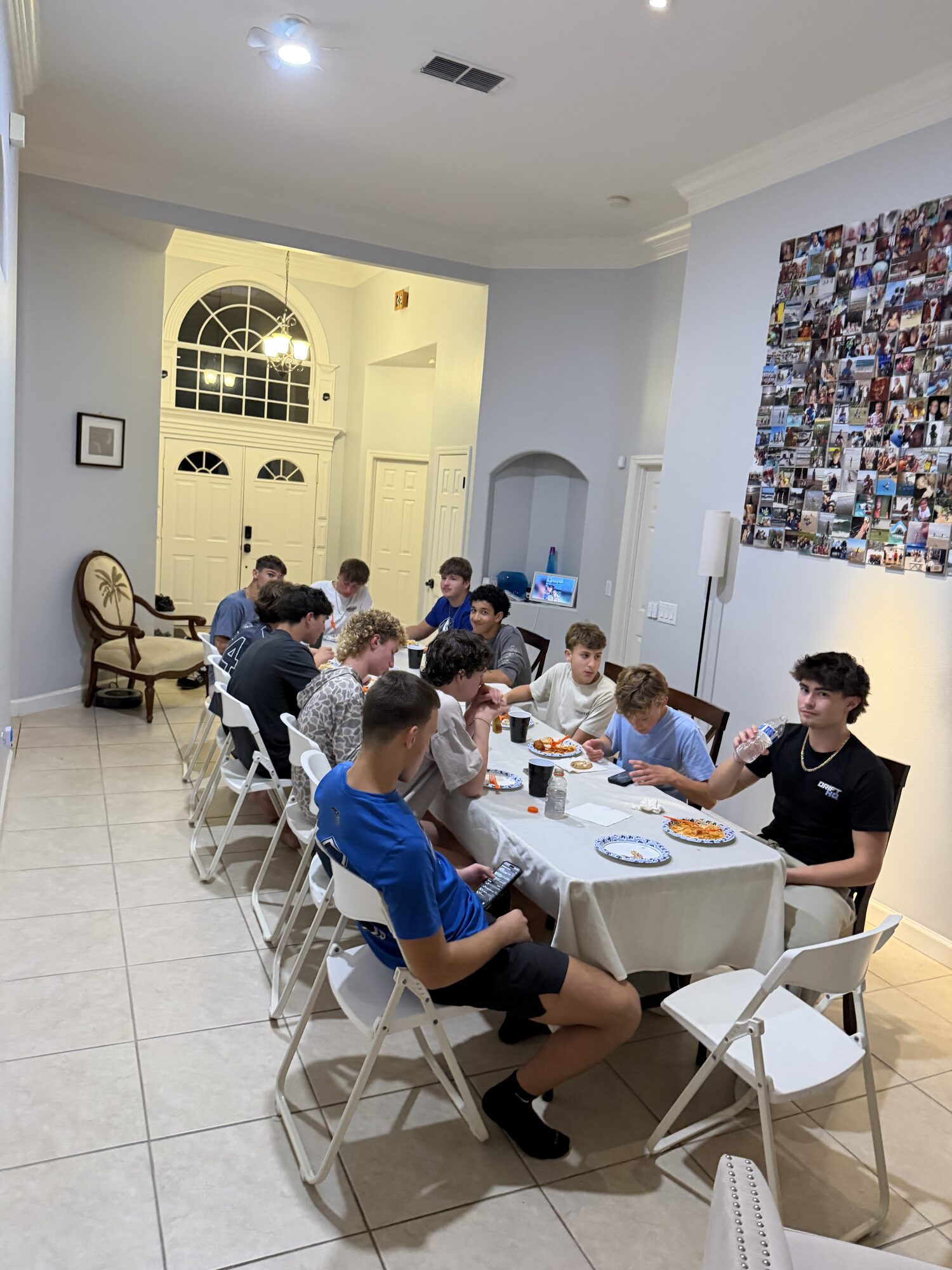LBRA boys around a long table at a teammate's house for a pre-race pasta party